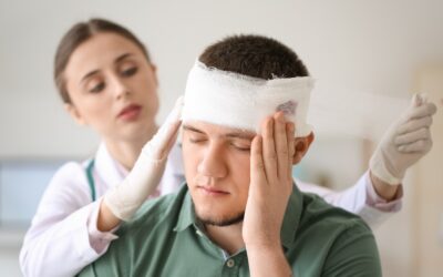 Emergency doctor examining a patient with head injury in trauma care unit