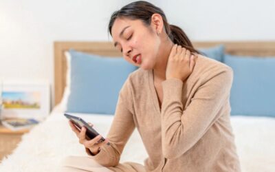 Woman experiencing neck pain and tingling sensations in her hands due to cervical nerve compression.
