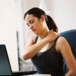 Woman suffering from chronic spine pain despite medication due to an underlying untreated spinal condition