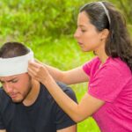 Motorcyclist experiencing dizziness and headache after a road accident, highlighting the importance of immediate neurological evaluation during the Golden Hour.