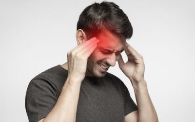 Man experiencing persistent headaches after a head injury, highlighting the importance of neurological evaluation following an accident.