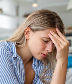 Man experiencing dizziness and headache after a minor head injury, highlighting the risk of serious brain complications despite seemingly mild trauma.